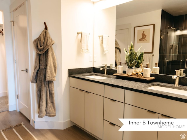 bathroom featuring vanity, hardwood / wood-style floors, and walk in shower