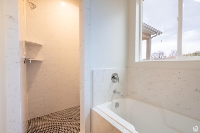 bathroom featuring shower with separate bathtub