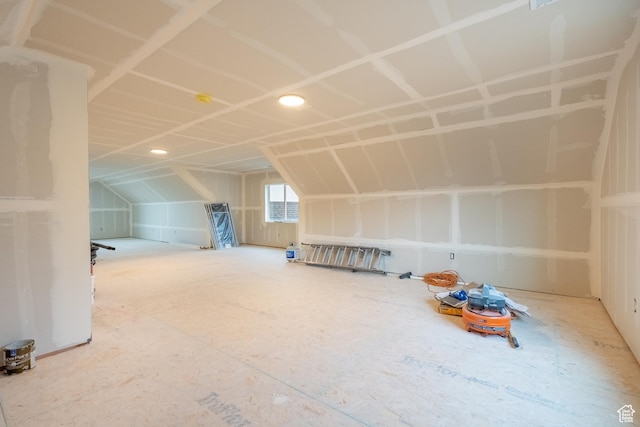 additional living space featuring lofted ceiling