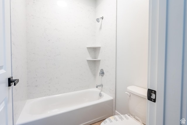 bathroom featuring bathing tub / shower combination and toilet
