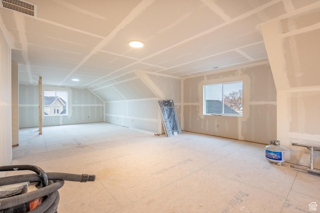additional living space featuring lofted ceiling