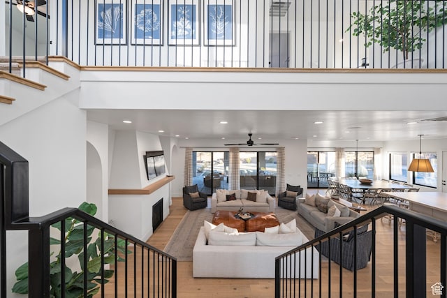 4862 N Sand Cove Cir, St George, UT 84770 - living room featuring light hardwood / wood-style floors, ceiling fan, and a high ceiling
