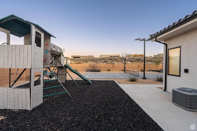 4862 N Sand Cove Cir, St George, UT 84770 - playground at dusk featuring basketball court, tennis court, and central air condition unit