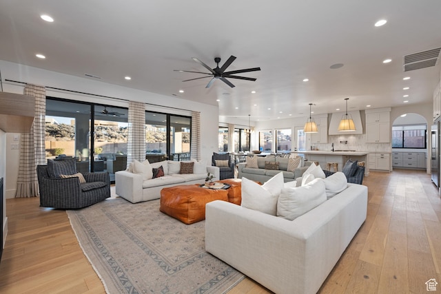 4862 N Sand Cove Cir, St George, UT 84770 - living room with ceiling fan, a wealth of natural light, and light hardwood / wood-style floors