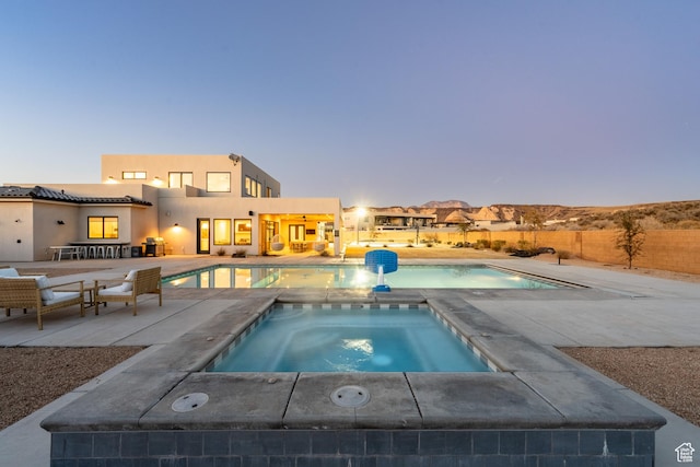 4862 N Sand Cove Cir, St George, UT 84770 - pool at dusk featuring an in ground hot tub and a patio area