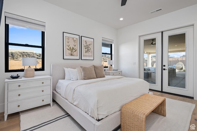 4862 N Sand Cove Cir, St George, UT 84770 - bedroom with ceiling fan, light hardwood / wood-style floors, multiple windows, and access to outside
