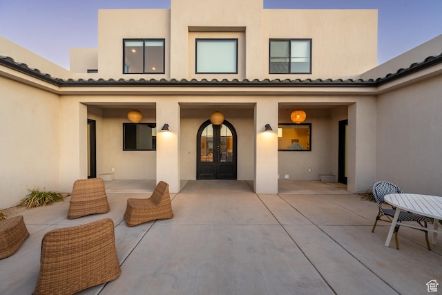 4862 N Sand Cove Cir, St George, UT 84770 - exterior entry at dusk with french doors and a patio