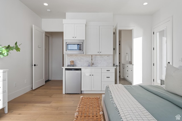 4862 N Sand Cove Cir, St George, UT 84770 - kitchen with white cabinetry, sink, stainless steel microwave, and dishwashing machine