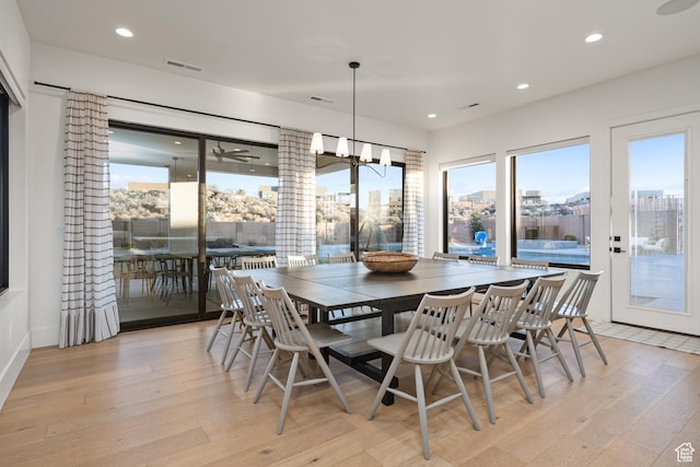 4862 N Sand Cove Cir, St George, UT 84770 - dining area with light hardwood / wood-style floors and a chandelier