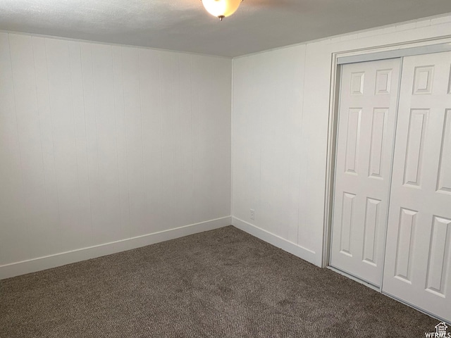 230 N 3rd St, Tooele, UT 84074 - unfurnished bedroom featuring dark colored carpet and a closet
