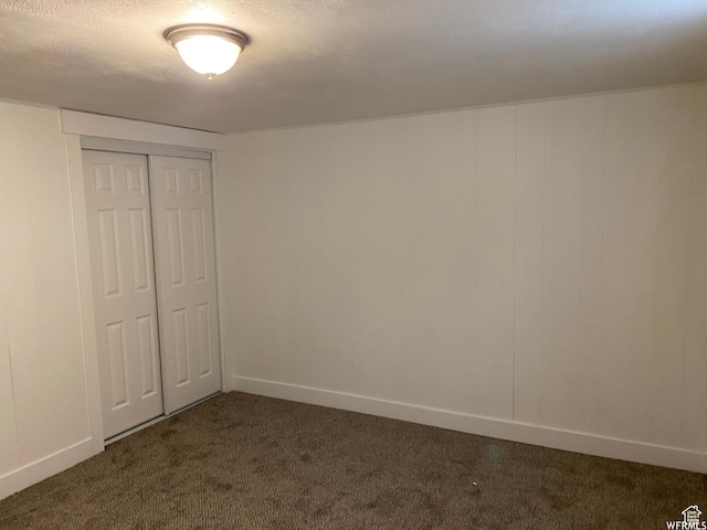 230 N 3rd St, Tooele, UT 84074 - unfurnished bedroom with a textured ceiling, dark carpet, and a closet
