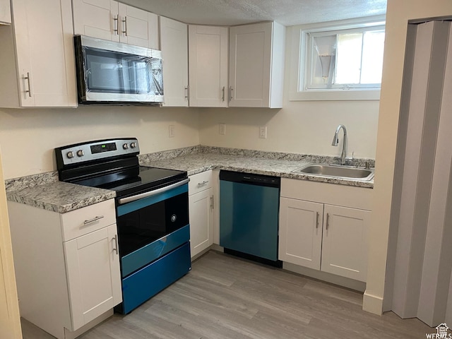 230 N 3rd St, Tooele, UT 84074 - kitchen featuring white cabinetry, stainless steel appliances, light hardwood / wood-style floors, and sink
