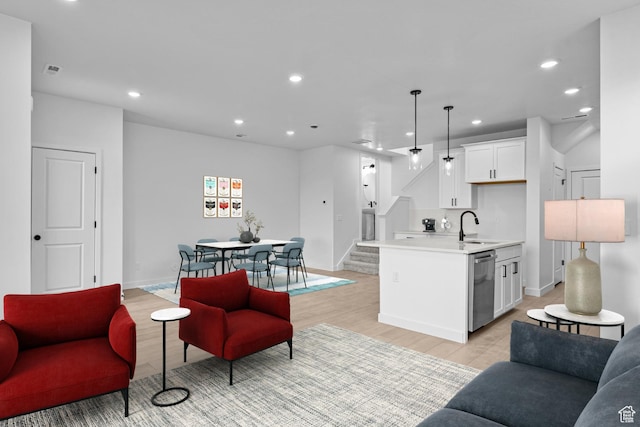 2869 S Ritter Row W Unit 54, West Valley City, UT 84128 - living area with stairs, light wood-type flooring, baseboards, and recessed lighting