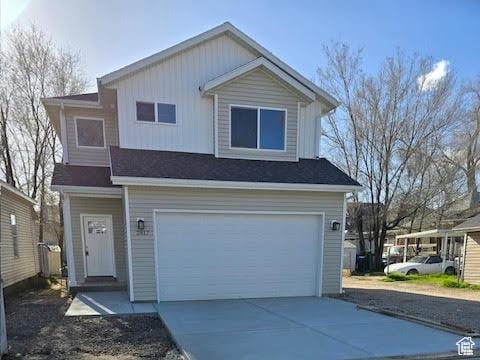 view of front of property with a carport and a garage