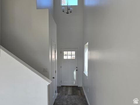 doorway with a high ceiling and a chandelier