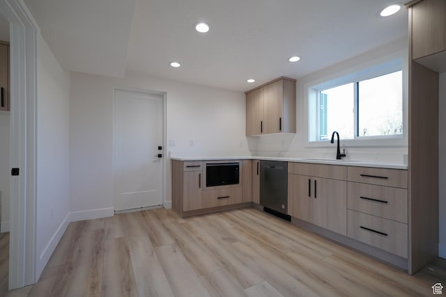 kitchen featuring sink, light hardwood / wood-style flooring, light brown cabinetry, and black appliances