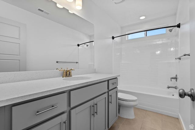 full bathroom featuring vanity, toilet, bathing tub / shower combination, and tile patterned flooring