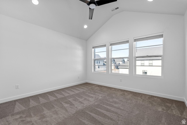 empty room with lofted ceiling, carpet floors, and ceiling fan