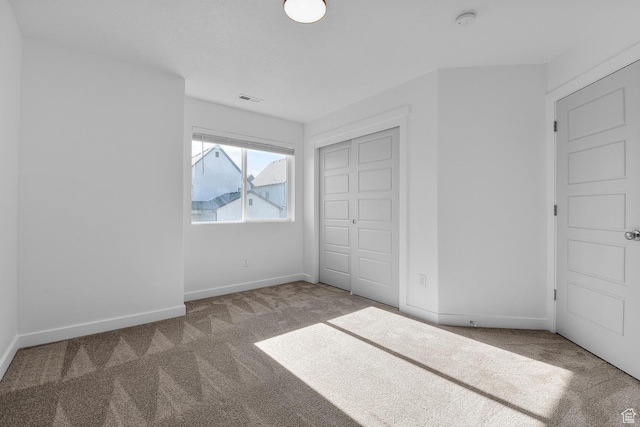 unfurnished bedroom featuring a closet and carpet flooring