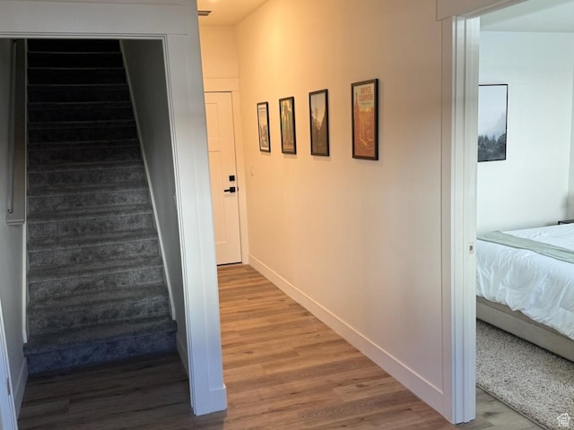 stairway featuring wood finished floors and baseboards