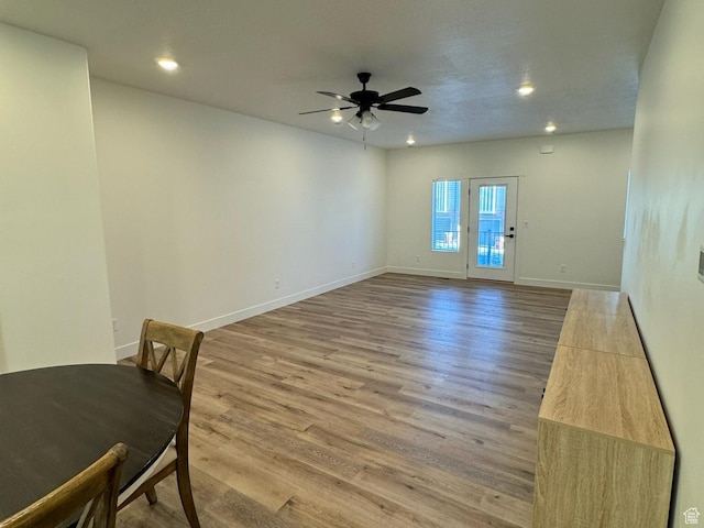 unfurnished living room with recessed lighting, baseboards, light wood-type flooring, and a ceiling fan