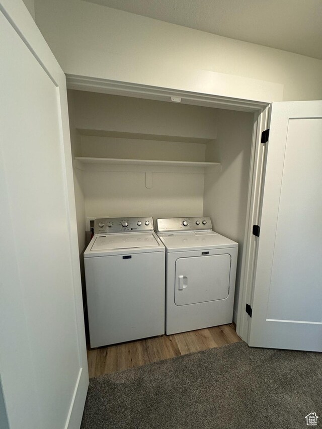laundry room featuring laundry area, light wood-style flooring, and washer and clothes dryer