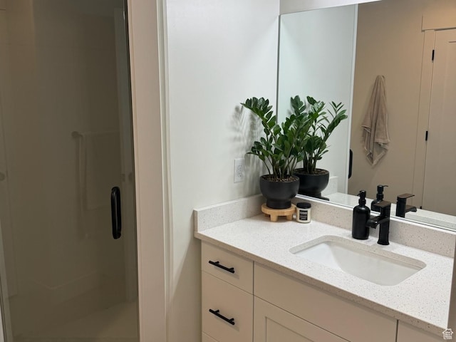 full bath with a shower stall and vanity