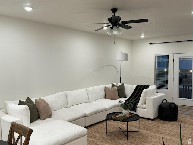 living area with recessed lighting, a ceiling fan, and wood finished floors