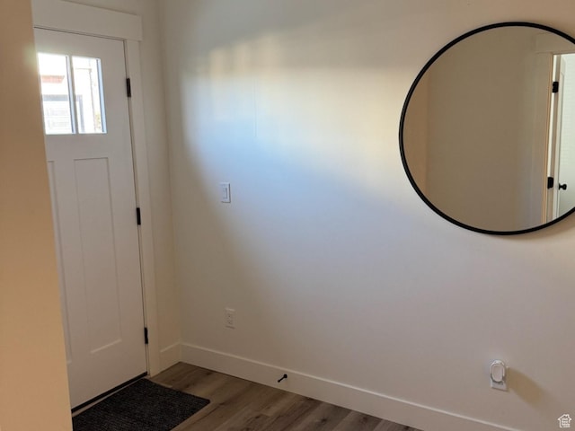 foyer featuring baseboards and light wood-style floors