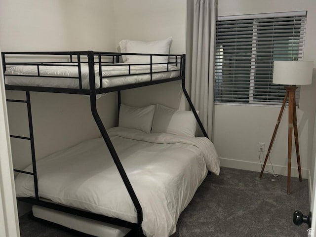 bedroom featuring baseboards and carpet
