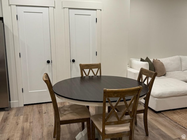 dining space with light wood-style flooring