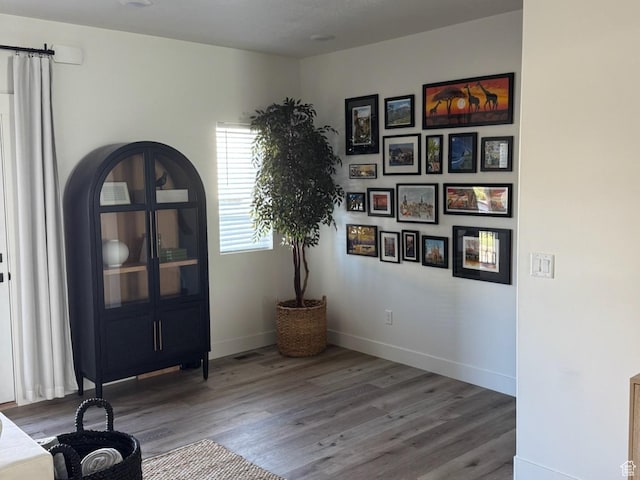 interior space featuring baseboards and wood finished floors