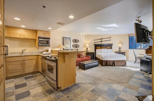 bedroom with visible vents, dark colored carpet, a sink, and recessed lighting