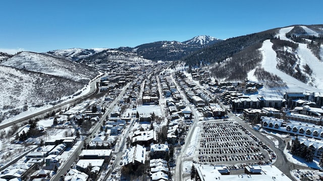 snowy aerial view featuring a mountain view