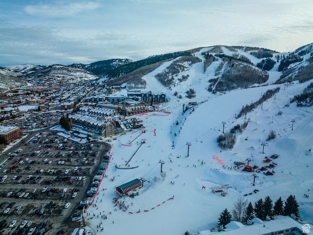 snowy aerial view with a mountain view