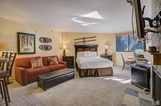 bedroom with carpet floors and a textured wall