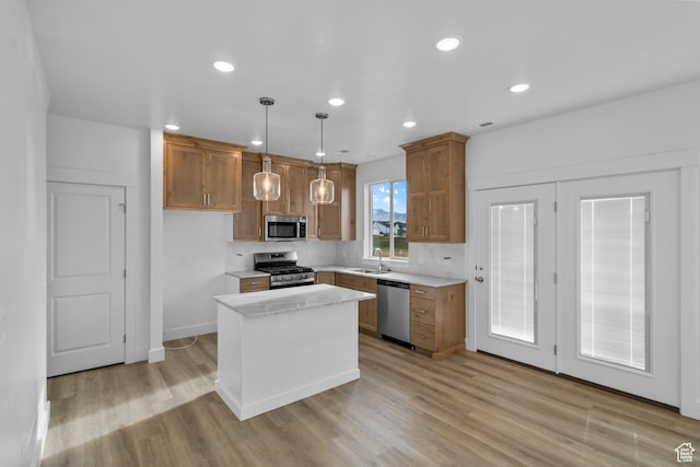 550 N 735 W, Smithfield, UT 84335 - kitchen featuring sink, light hardwood / wood-style flooring, a kitchen island, pendant lighting, and stainless steel appliances