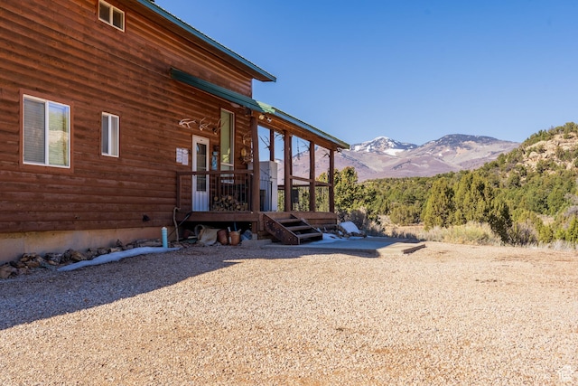 view of property exterior with a mountain view
