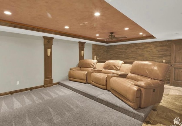 14548 S Rose Ave, Herriman, UT 84096 - carpeted home theater featuring ornamental molding, wooden walls, a tray ceiling, ceiling fan, and decorative columns