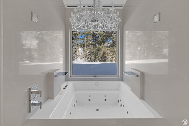 bathroom with a washtub and a notable chandelier