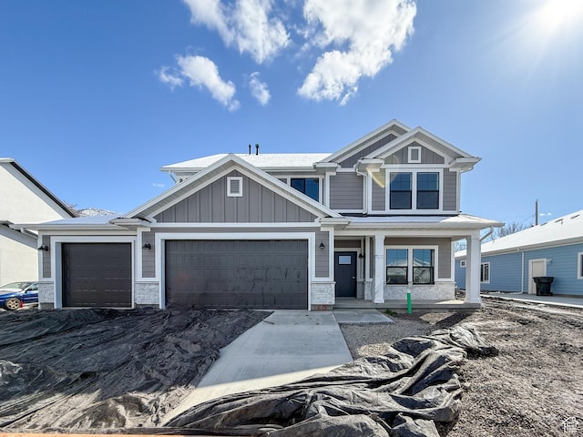 craftsman inspired home with board and batten siding and an attached garage
