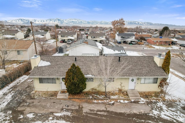 snowy aerial view featuring a mountain view
