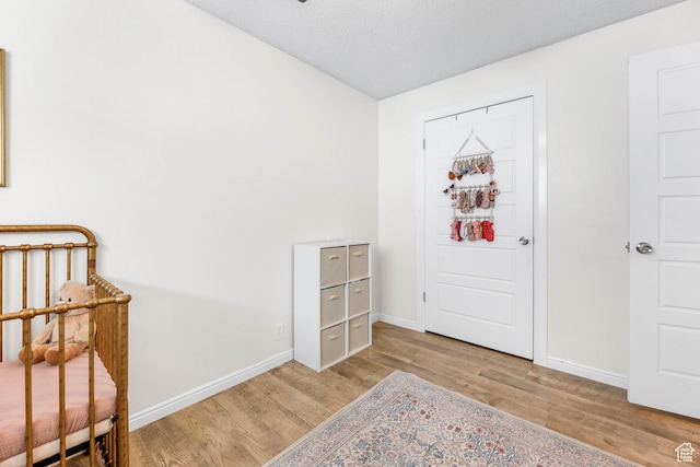 interior space featuring light hardwood / wood-style flooring and a textured ceiling