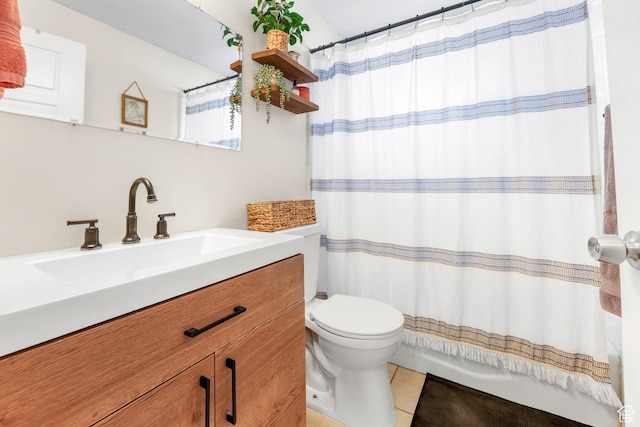bathroom with tile patterned floors, vanity, and toilet