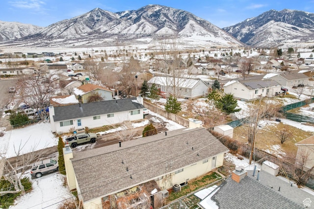 snowy aerial view featuring a mountain view