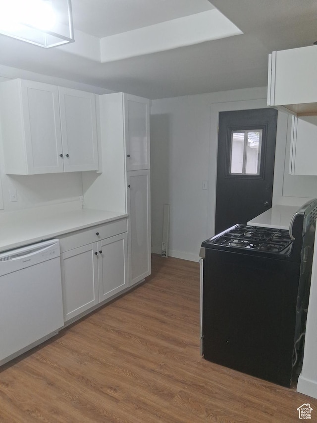 541 41st St, South Ogden, UT 84403 - kitchen with black gas range oven, dishwasher, white cabinetry, light wood-type flooring, and light countertops
