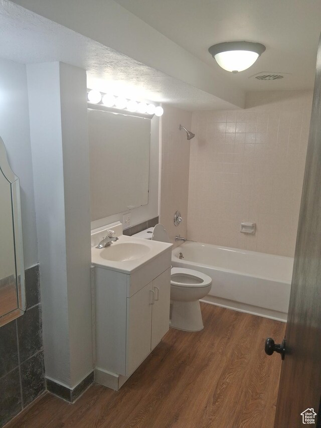 541 41st St, South Ogden, UT 84403 - full bath featuring wood finished floors, bathtub / shower combination, toilet, and vanity