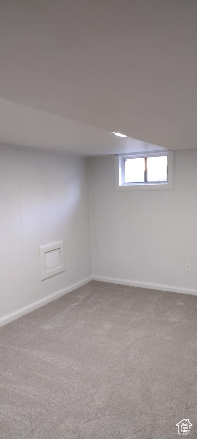 basement featuring baseboards and carpet