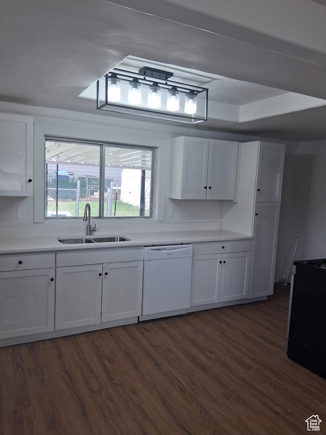 kitchen featuring white cabinets, light countertops, dark wood-type flooring, a sink, and white dishwasher