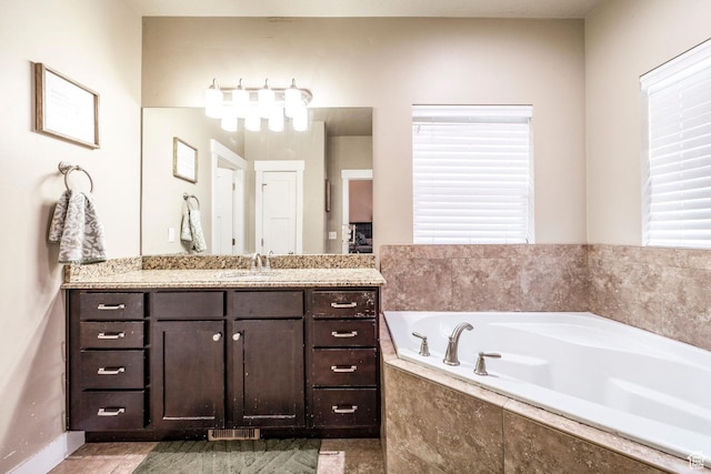 7104 S Cadens Cv, Cottonwood Heights, UT 84121 - bathroom with a relaxing tiled tub and vanity